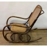 A bentwood rocking armchair, with a canework back and seat generally good, the canework holes look