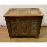 An oak coffer, incorporating 17th century panels carved cherubs and foliage, 89 cm wide