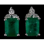 A pair of 14ct white gold, emerald and diamond stud earrings, the emeralds approx. 1.66ct and the