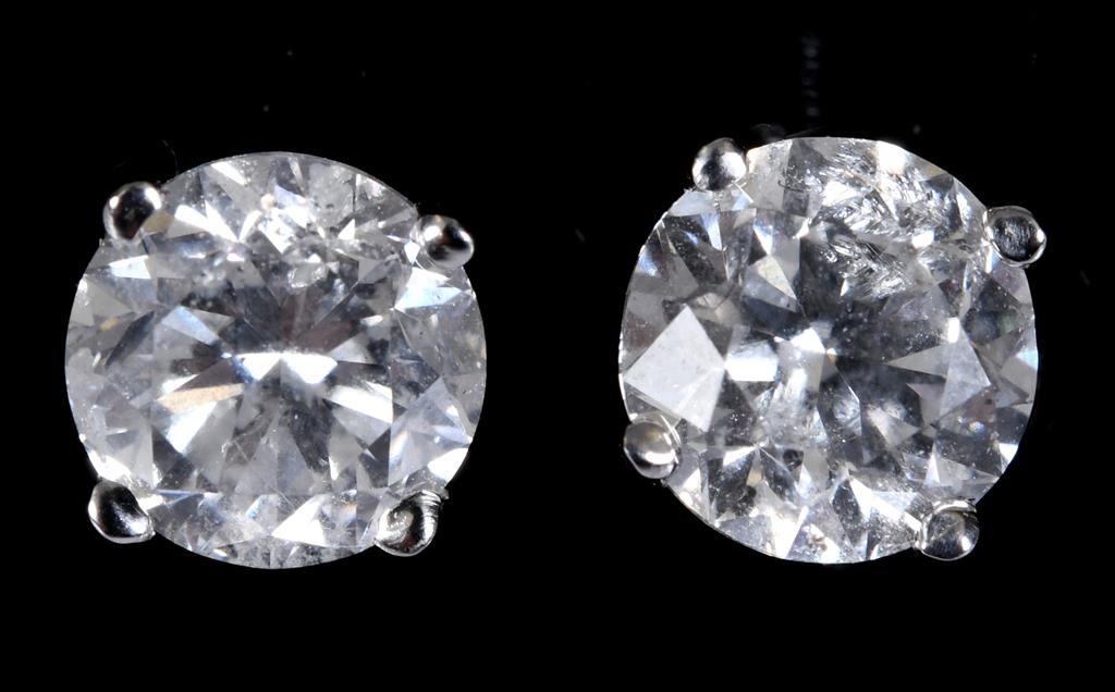 A pair of white gold and diamond stud earrings, approx. 1.41ct