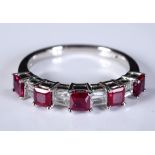 An 18ct white gold and nine stone ruby and diamond ring, the Princess cut rubies approx. 0.76ct, the