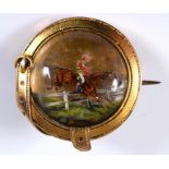 An Essex crystal style brooch, decorated a horse and jockey jumping a fence, in a yellow coloured
