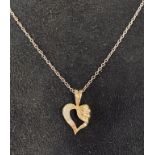 A 14ct gold heart shaped diamond pendant on chain