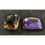 An amethyst stone and a citrine stone amethyst stone chipped to corner