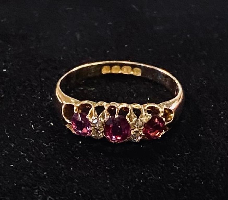 An 18ct gold, ruby and diamond chip ring, approx. ring size L Generally good condition, centre