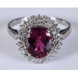 An 18ct white gold, rubellite and diamond cluster ring, approx. ring size M½ Report by RB