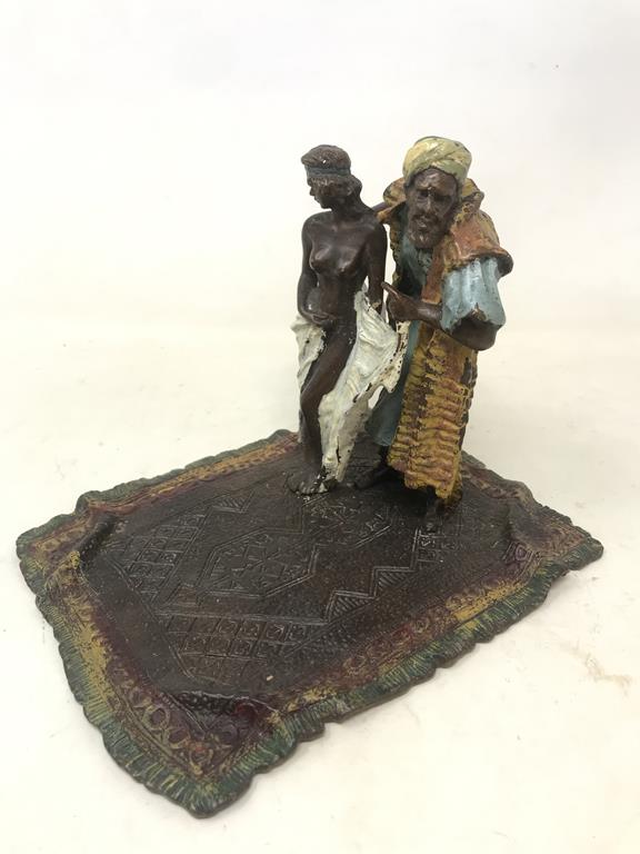 A modern painted bronze figure of a trader, standing on a rug, 16 cm high This item is 20th/21st