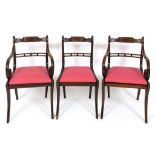 A set of eight simulated rosewood and brass inlaid dining chairs, with drop in seats and sabre