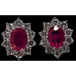 A pair of 18ct white gold and oval ruby and diamond cluster stud earrings, the rubies approx. 1.90ct