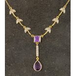 A modern gold plated Art Nouveau style pendant necklace inset with purple and white stones Report by