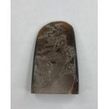 A Chinese hardstone carved pebble, decorated with two figures below a knarled tree, height 8 cm