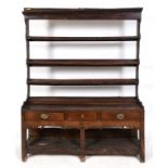 A 19th century oak dresser, the three tier plate rack above a base with three frieze drawers above a