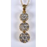 An 18ct gold and diamond graduated triple flowerhead pendant, on chain