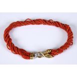 A multi-strand coral bead necklace, with an 18ct gold and diamond clasp