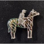 A silver pendant/brooch, the form of a horse and jockey