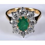 An 18ct white and yellow gold, oval emerald and diamond cluster ring, the central emerald approx.