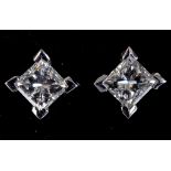 A pair of 18ct white gold and princess cut diamond four claw stud earrings, 0.74ct (total)