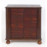 An unusual mahogany folio cabinet, the tambour front sliding to reveal two rows of twelve drawers,