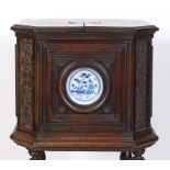 An unusual 19th century Continental walnut cabinet, of square form with canted corners, carved