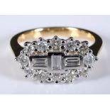 An 18ct yellow and white gold and diamond cluster ring, set baguette and round cut diamonds, approx.