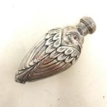 A silver bird shaped perfume bottle Report by RB Modern