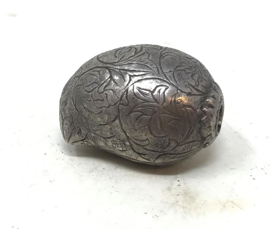 An Indian silver coloured metal scent bottle, of melon form, engraved foliage, 3.5 cm