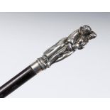 A slender 19th century walking cane, the Continental silver coloured metal handle with an erotic