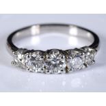 A white coloured metal and five stone diamond half hoop ring, approx. ring size N, diamonds