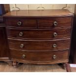 An early 19th century bow front mahogany chest, of two short and three graduated long drawers, on