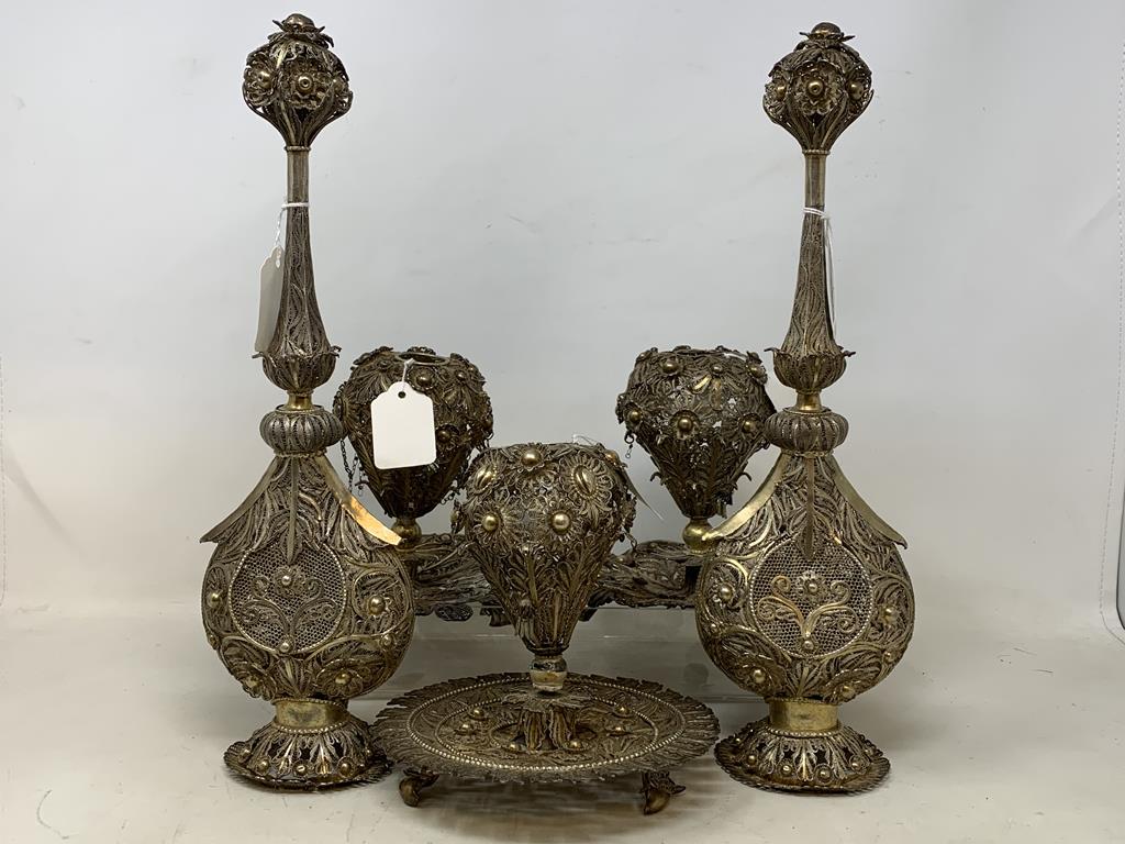 An Indian pair of silver coloured metal filigree work rosewater sprinklers, 34 cm high, and three