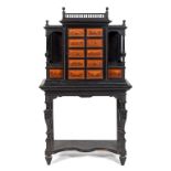 A 19th century Continental ebonised specimen cabinet on stand, the cabinet having turned