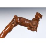 A good one piece folk art walking stick, a dog with a pheasant in its mouth, 96 cm