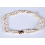 A two row graduated cultured pearl necklace, with a 9ct gold clasp