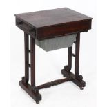 A Regency mahogany work table, the end frieze drawer above a pull out work bag, on scroll end
