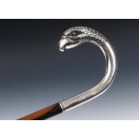 A 19th century Continental silver coloured metal crook handle cane in the form of an eagle, on a