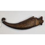 An Indian carved wood powder flask, in the form of a fish, with gilt decoration, 22 cm wide