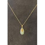 A 9ct gold, emerald and diamond baby shoe pendant, on a 9ct gold chain Report by RB Modern
