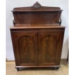 An early 19th century mahogany chiffonier, with a pair of arched panel doors, on turned feet, 95