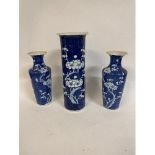 A pair of Chinese blue and white vases, decorated blossoms, 20 cm high, and another similar, 26 cm