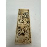 A 19th century Chinese carved ivory panel, of rectangular form with re-entrant corners, decorated