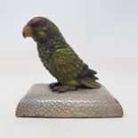 An early 20th century desk weight, in the form of a cold painted bronze parrot, on a shagreen