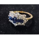 A 9ct gold, three baguette sapphire and twelve stone diamond ring Modern