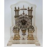 A brass skeleton clock, the silvered chapter ring with Roman numerals, fitted a single fusee