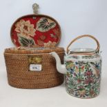 A Chinese famille rose teapot and cover, in a fitted wicker case, lacks tea bowls, a pair of crackle