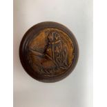 A treen snuff box, the cover carved a horse's head, the inside with a paper label inscribed and