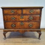 A walnut chest, having two short and two long drawers, on shell carved cabriole legs, 98 cm wide