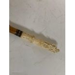 A late 19th/early 20th century walking stick, the ivory handle carved Pan playing pipes, probably