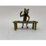 A novelty painted bronze figure, of a croupier at a table, 9 cm high Modern