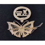 A Sterling silver hair ornament, in the form of a butterfly and a badge (2)