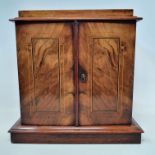 A Victorian inlaid walnut table top cabinet, having a pair of panel doors enclosing three drawers,